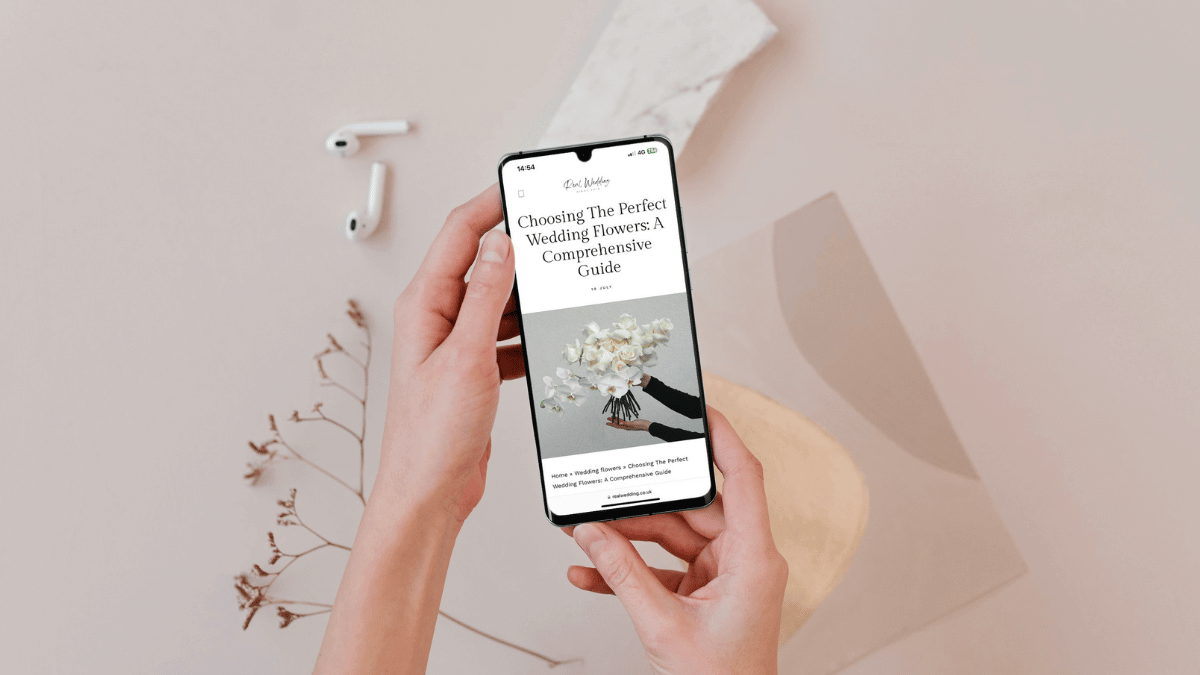 holding a phone with a blog post showing on it